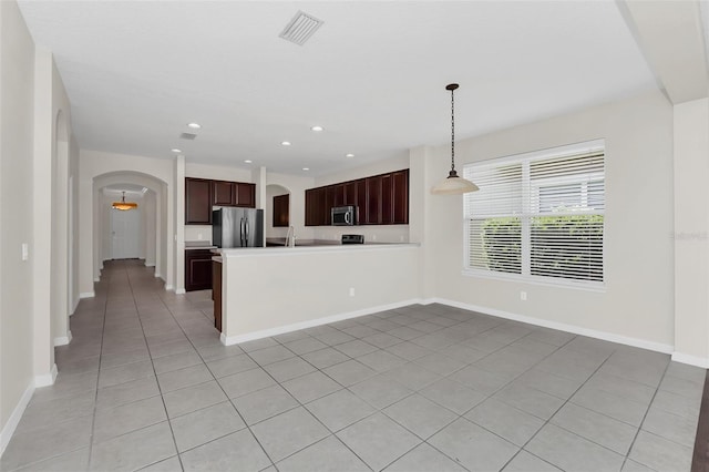 kitchen featuring visible vents, recessed lighting, arched walkways, appliances with stainless steel finishes, and baseboards