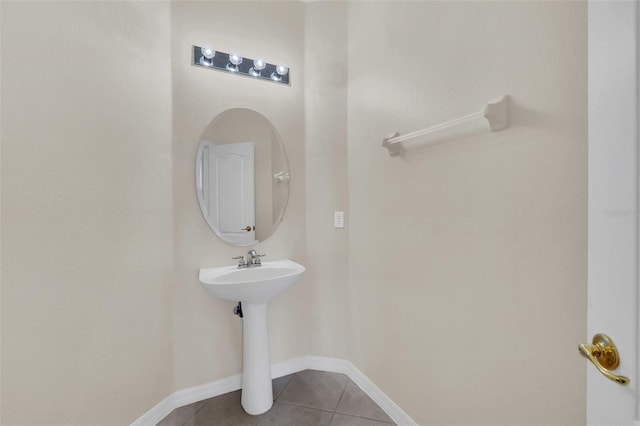 bathroom featuring baseboards and tile patterned flooring