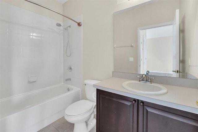 bathroom featuring tile patterned floors, washtub / shower combination, toilet, and vanity