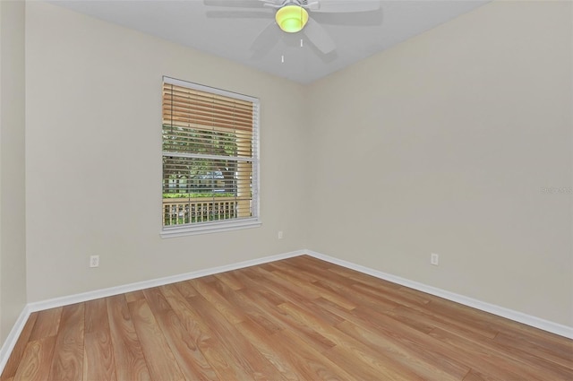 unfurnished room featuring light wood finished floors, a ceiling fan, and baseboards