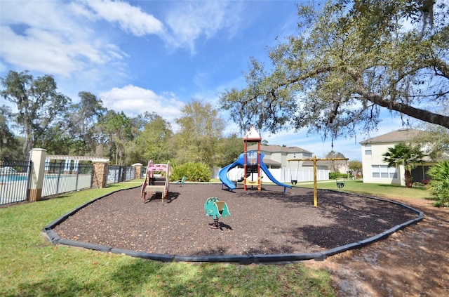 community playground featuring a yard and fence