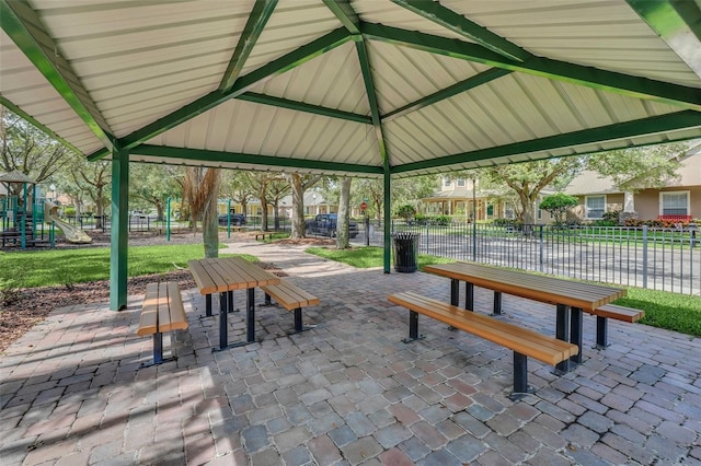 view of community featuring a gazebo, fence, and playground community