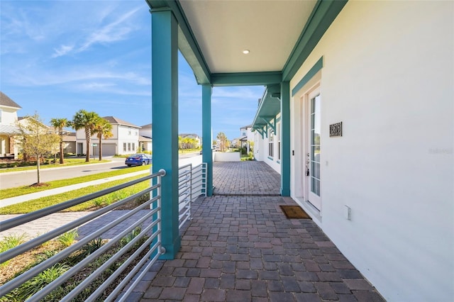 view of patio featuring a residential view and a balcony