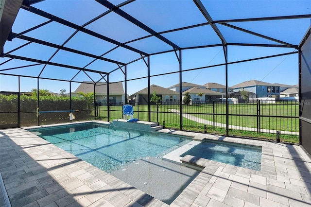 view of pool with a pool with connected hot tub, a patio area, a lanai, a lawn, and a residential view