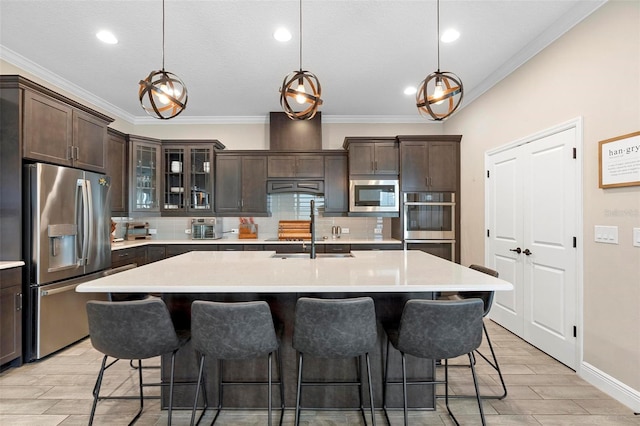 kitchen featuring a sink, decorative backsplash, appliances with stainless steel finishes, and light countertops