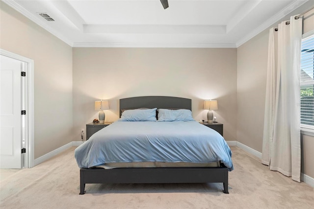 bedroom with baseboards, visible vents, a raised ceiling, and light carpet