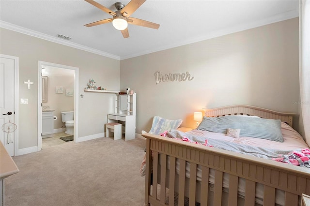 bedroom featuring visible vents, baseboards, ornamental molding, light carpet, and ensuite bathroom