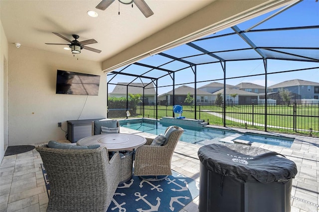 view of patio featuring a ceiling fan, fence, a residential view, a fenced in pool, and a lanai