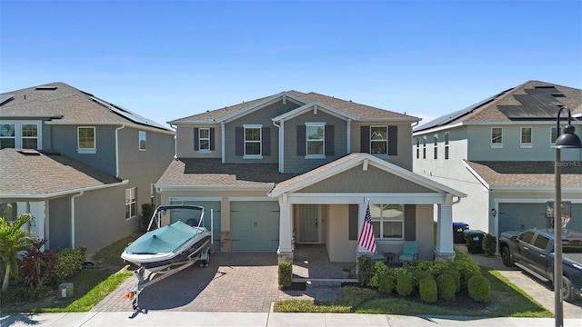 view of front of property featuring decorative driveway and an attached garage