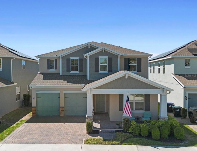 10732 Petrillo Way, Winter Garden, FL 34787 - craftsman inspired home featuring a garage, roof with shingles, a porch, and decorative driveway
