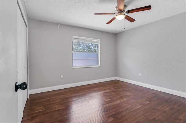 unfurnished bedroom featuring baseboards, a textured ceiling, and wood finished floors