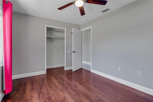 unfurnished bedroom with visible vents, baseboards, wood finished floors, a closet, and a ceiling fan