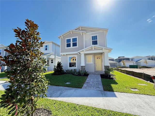 view of front of home with stucco siding, a front lawn, and fence