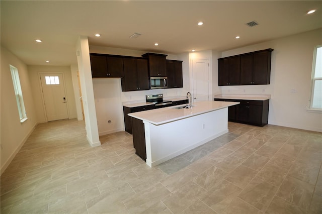 kitchen with visible vents, recessed lighting, a sink, stainless steel appliances, and light countertops