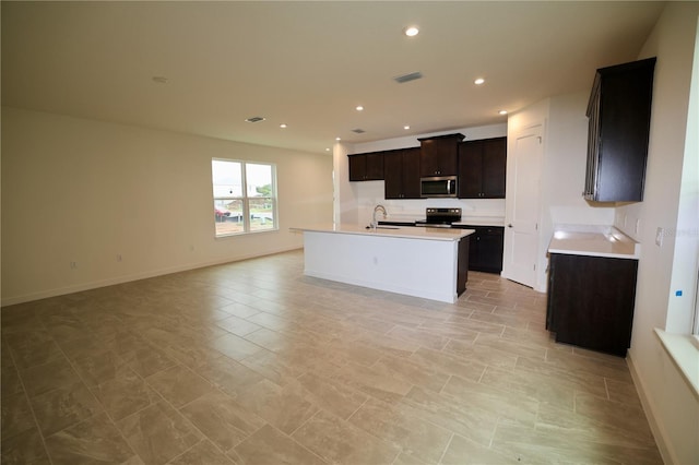 kitchen featuring visible vents, a sink, open floor plan, recessed lighting, and appliances with stainless steel finishes