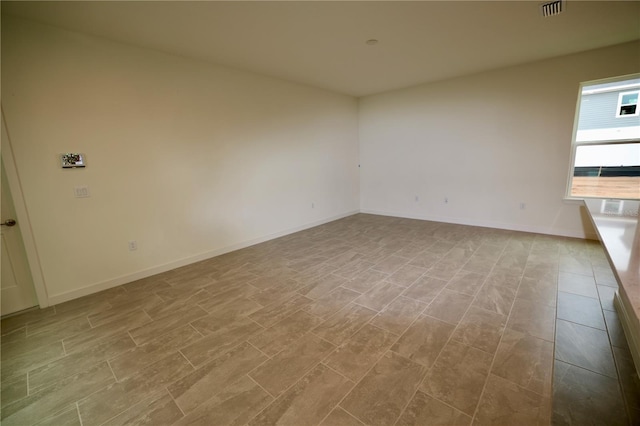 empty room featuring visible vents and baseboards