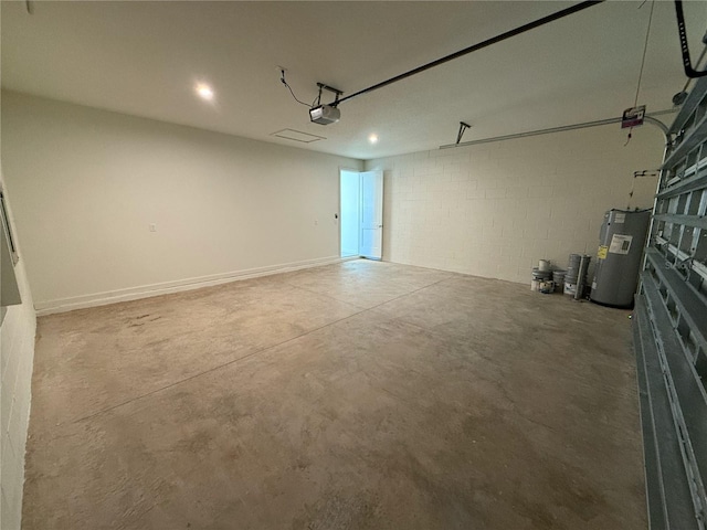 garage with concrete block wall, a garage door opener, and water heater