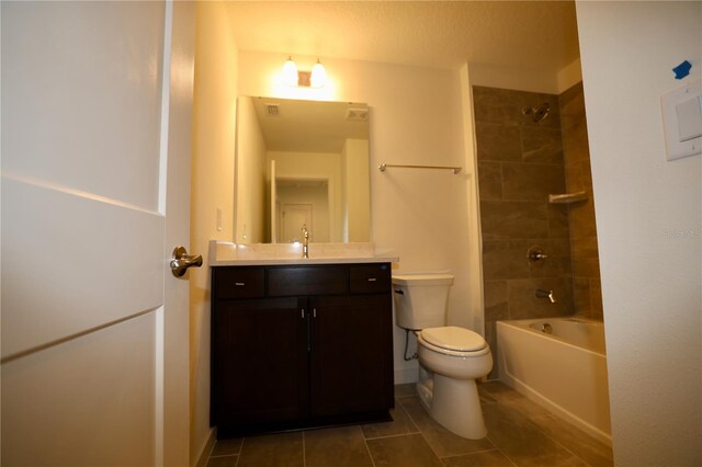 bathroom with tile patterned floors, shower / washtub combination, toilet, and vanity