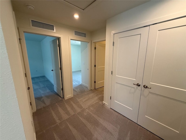 hallway with recessed lighting, visible vents, baseboards, and carpet flooring