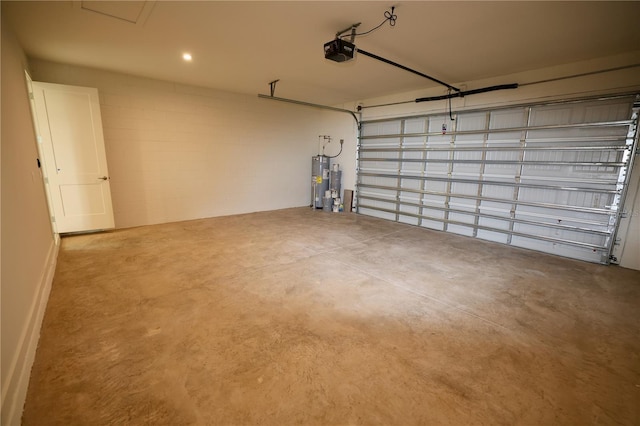 garage featuring electric water heater and a garage door opener