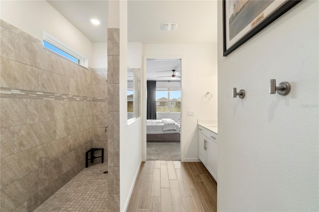 bathroom featuring connected bathroom, a healthy amount of sunlight, walk in shower, and wood tiled floor