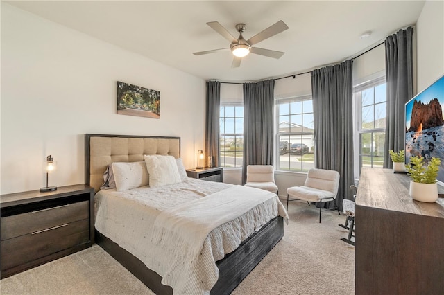 bedroom featuring ceiling fan and carpet