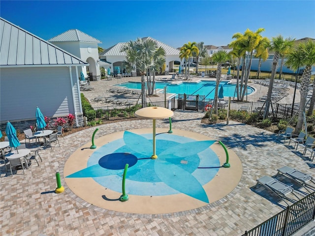 pool with a patio and fence