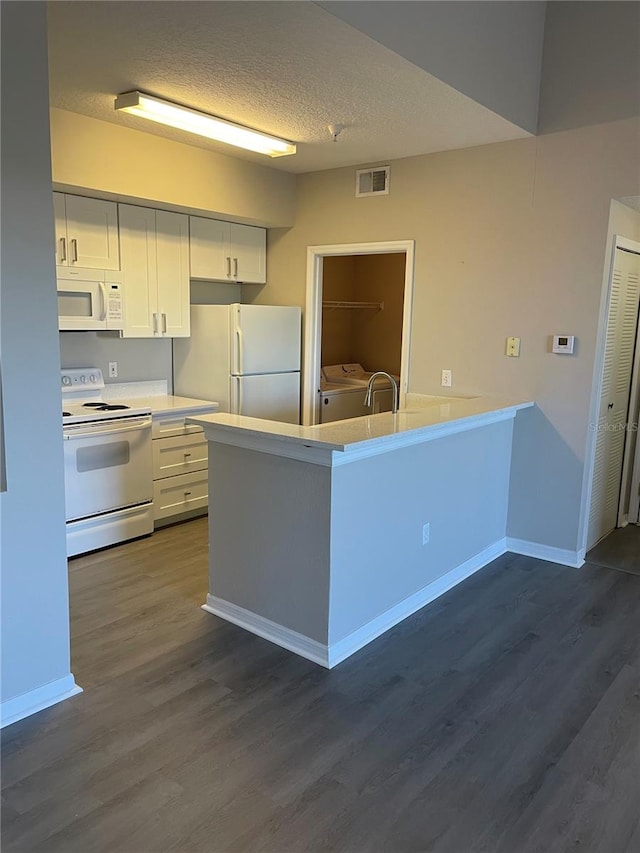 kitchen featuring light countertops, dark wood-style floors, white cabinets, white appliances, and separate washer and dryer