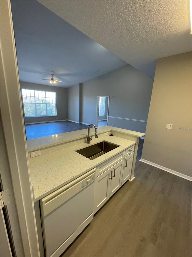 kitchen featuring white cabinetry, dark wood-type flooring, white dishwasher, a textured ceiling, and a sink