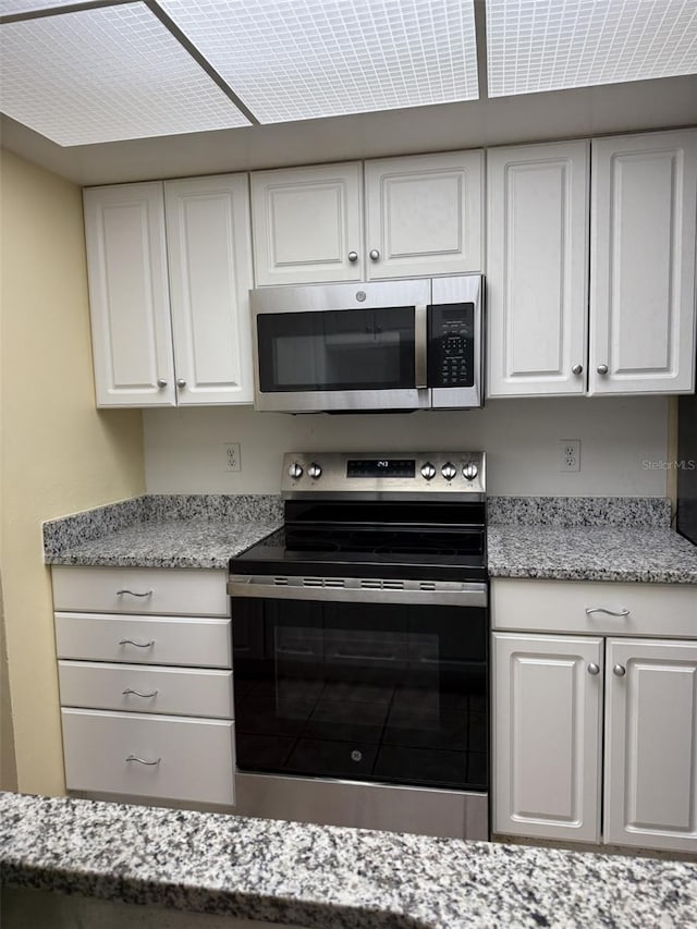 kitchen featuring appliances with stainless steel finishes and white cabinetry