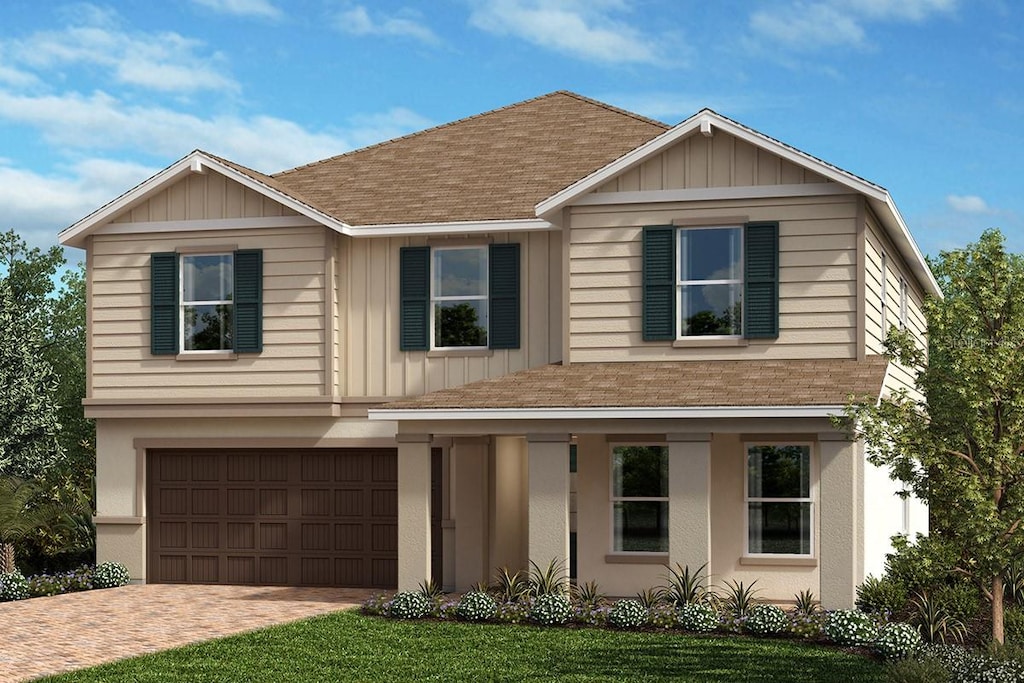 view of front of house with board and batten siding, a shingled roof, decorative driveway, and a garage