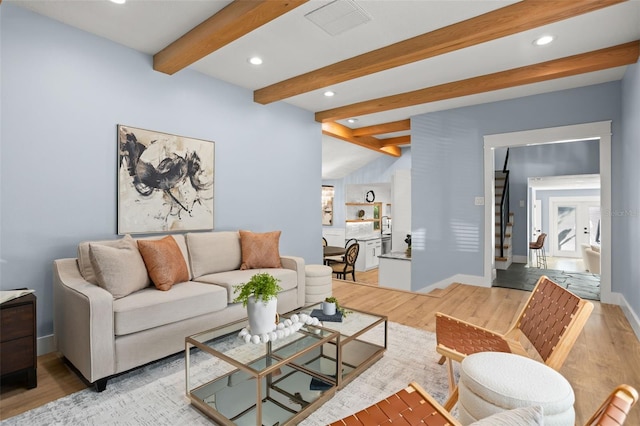 living room featuring visible vents, vaulted ceiling with beams, baseboards, light wood-type flooring, and recessed lighting