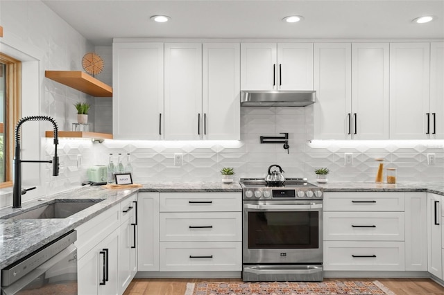 kitchen with open shelves, under cabinet range hood, dishwasher, stainless steel range with electric stovetop, and a sink