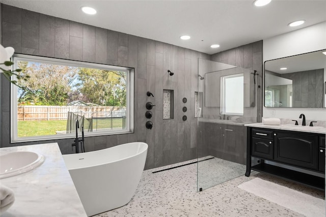 full bathroom featuring vanity, walk in shower, recessed lighting, and a freestanding bath