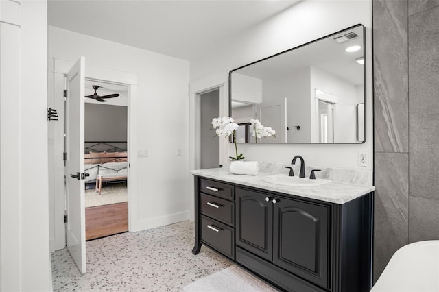 bathroom featuring vanity, baseboards, visible vents, and ceiling fan