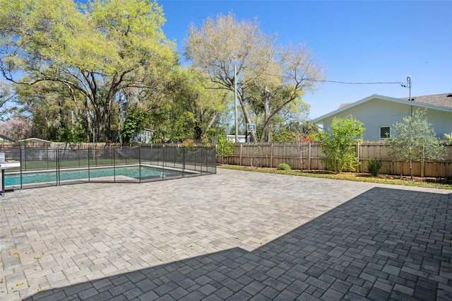 view of swimming pool featuring a fenced in pool, a patio, and fence