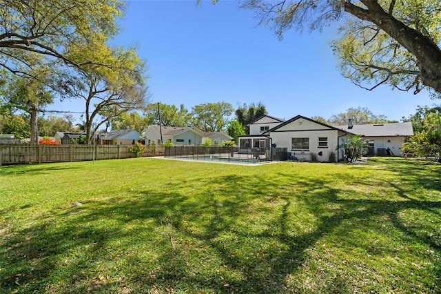 view of yard featuring a fenced in pool and fence