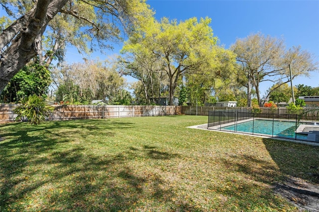 view of yard featuring a fenced in pool and a fenced backyard