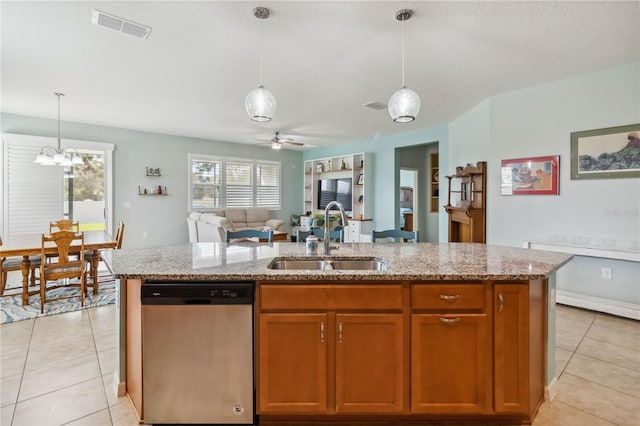 kitchen featuring light tile patterned floors, a sink, visible vents, and stainless steel dishwasher