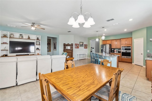 dining room with visible vents, light tile patterned flooring, and ceiling fan with notable chandelier