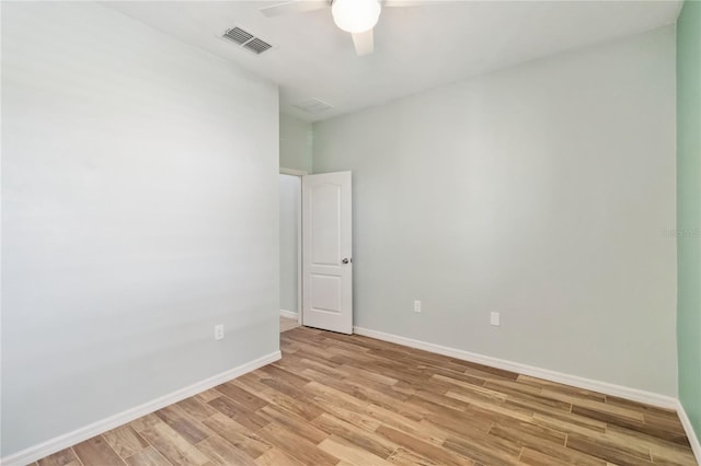 empty room with ceiling fan, visible vents, baseboards, and light wood-style flooring