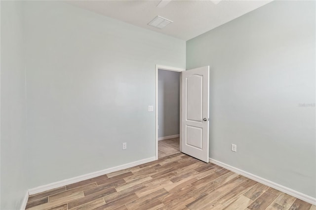 spare room featuring visible vents, baseboards, and light wood-style flooring