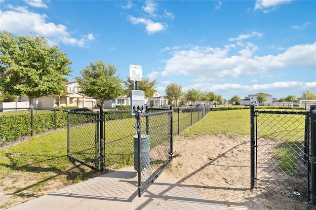 exterior space with a residential view, a lawn, and fence