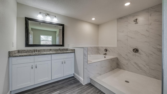 5963 Virtudes St, Sebring, FL 33872 - full bath featuring tiled shower, double vanity, wood finished floors, and recessed lighting