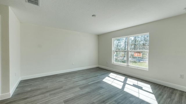 5963 Virtudes St, Sebring, FL 33872 - unfurnished room featuring baseboards, wood finished floors, and a textured ceiling