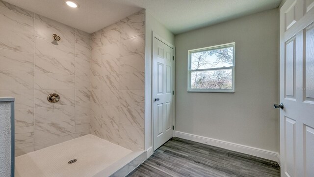 5963 Virtudes St, Sebring, FL 33872 - bathroom with a tile shower, baseboards, wood finished floors, and recessed lighting