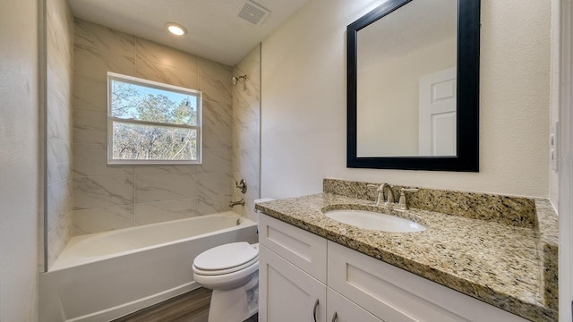 5963 Virtudes St, Sebring, FL 33872 - full bath featuring toilet, bathtub / shower combination, vanity, and wood finished floors