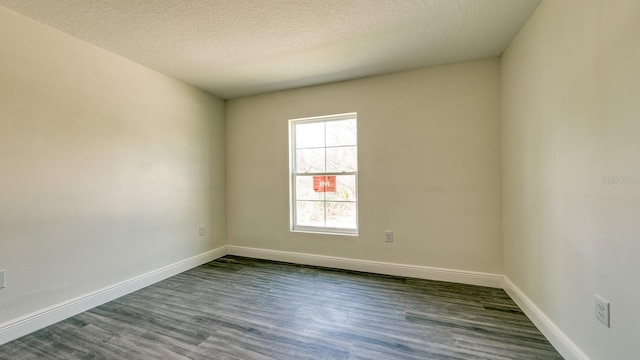 5963 Virtudes St, Sebring, FL 33872 - unfurnished room featuring dark wood-type flooring, baseboards, and a textured ceiling