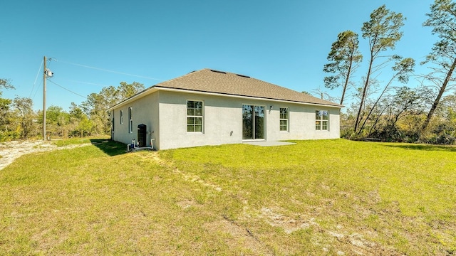 5963 Virtudes St, Sebring, FL 33872 - back of house featuring stucco siding and a yard