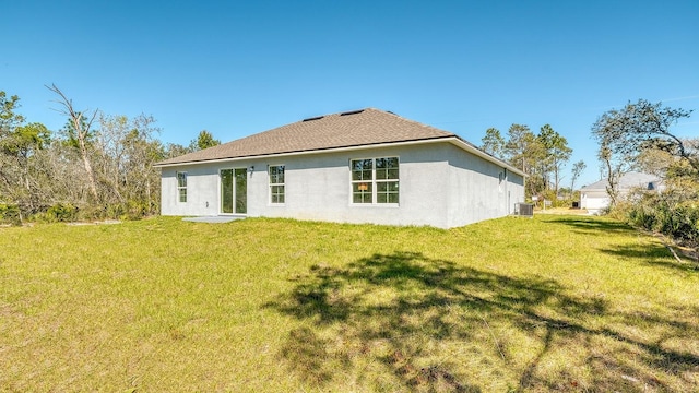 5963 Virtudes St, Sebring, FL 33872 - rear view of property with stucco siding, a lawn, and central air condition unit